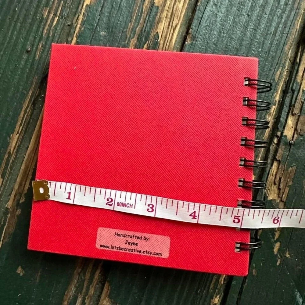 Red and yellow spiral website address book with ribbon